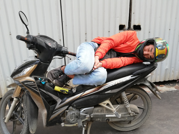 Woman sleeping on her motorcycle about sleep deprivation