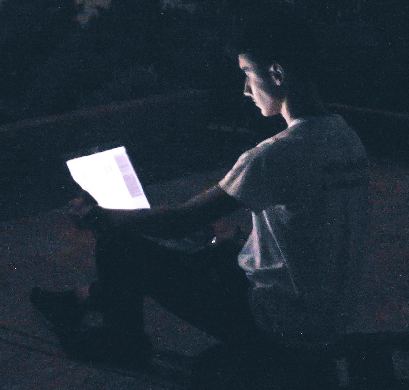 reading on ipad tablet in the dark, glowing screens